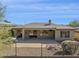 Exterior view of home featuring a covered patio area and desert landscaping at 2740 W Plum Hollow Dr, Anthem, AZ 85086