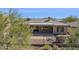 Exterior view of home featuring a covered patio area and desert landscaping at 2740 W Plum Hollow Dr, Anthem, AZ 85086