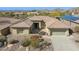 Aerial view of the attractive home showing desert landscaping and three car garage at 2740 W Plum Hollow Dr, Anthem, AZ 85086