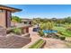 Scenic golf course view with lush greenery, a water feature, and golf carts parked nearby at 2740 W Plum Hollow Dr, Anthem, AZ 85086