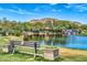 A scenic view of a pond and waterfall feature with a bench at 2740 W Plum Hollow Dr, Anthem, AZ 85086