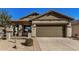 Front view of a single-story house with a brown garage door and stone accents at 30341 N Saddlebag Ln, San Tan Valley, AZ 85143