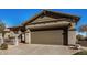 House exterior showcasing a two-car garage and neutral color palette at 30341 N Saddlebag Ln, San Tan Valley, AZ 85143