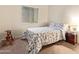 Bedroom with floral bedding, wood nightstand, and rocking horse at 4850 W Erie St, Chandler, AZ 85226