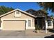 Tan one-story house with a two-car garage and landscaped yard at 4850 W Erie St, Chandler, AZ 85226