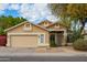 One-story house with tan exterior, two-car garage, and landscaped yard at 4850 W Erie St, Chandler, AZ 85226