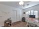 Well-lit bedroom with wood floors, a desk, and ample closet space at 7777 E 2Nd St # 303, Scottsdale, AZ 85251