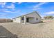 A neutral colored, one-story home with a gravel backyard and covered patio at 10810 W Torren Dr, Arizona City, AZ 85123