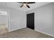 Carpeted bedroom with a ceiling fan and black closet doors at 10810 W Torren Dr, Arizona City, AZ 85123