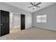 Spacious bedroom featuring neutral carpet, a ceiling fan, and a full bathroom with a shower at 10810 W Torren Dr, Arizona City, AZ 85123