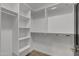 Bright walk-in closet with shelving and metal rods for optimal storage space at 10810 W Torren Dr, Arizona City, AZ 85123