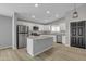 Modern kitchen featuring stainless steel appliances, island, and stylish cabinets at 10810 W Torren Dr, Arizona City, AZ 85123