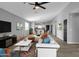 Inviting living room with contemporary decor flows seamlessly into the dining area and kitchen at 10810 W Torren Dr, Arizona City, AZ 85123