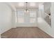 Bright dining area features hardwood floors, arched entryway and a modern chandelier at 14862 W Laurel Ln, Surprise, AZ 85379