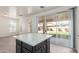 Kitchen island with dark cabinetry, marble countertops, and wood flooring at 14862 W Laurel Ln, Surprise, AZ 85379