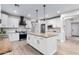 Bright kitchen with white cabinets, a center island with granite counter tops and stainless steel appliances at 17769 W Alexandria Way, Surprise, AZ 85388