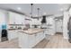 Bright kitchen with white cabinetry, granite countertops, stainless steel appliances and center island at 17769 W Alexandria Way, Surprise, AZ 85388