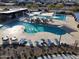 Aerial view of community pool with lounge chairs, shade coverings, and modern amenities at 23079 E Stacey Rd, Queen Creek, AZ 85142