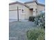 Tan one-story house with a two-car garage and cacti at 805 W Sunset Dr, Coolidge, AZ 85128