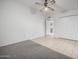 Bedroom with carpet flooring, ceiling fan, and a view of the bathroom at 10434 W Oakmont Dr, Sun City, AZ 85351