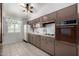 Retro kitchen with brown cabinets and tiled flooring at 10434 W Oakmont Dr, Sun City, AZ 85351