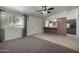 Living room with carpet flooring and a view of the kitchen at 10434 W Oakmont Dr, Sun City, AZ 85351