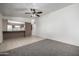 Bright living room featuring carpet and an open kitchen at 10434 W Oakmont Dr, Sun City, AZ 85351