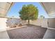 Small paved backyard with a mature orange tree and fountain at 10606 W Granada Dr, Sun City, AZ 85373