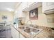 Kitchen features granite countertops and white cabinets at 10606 W Granada Dr, Sun City, AZ 85373