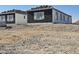 New home under construction with black stone, white trim, and a modern design at 1907 W Brooke Ln, Queen Creek, AZ 85144