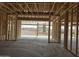 Interior framing of a new home's living area with a view to the back patio and mountains at 1907 W Brooke Ln, Queen Creek, AZ 85144