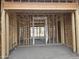 Interior framing of a new home showing an open doorway to the future living space at 1907 W Brooke Ln, Queen Creek, AZ 85144