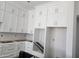 Crisp, white kitchen cabinets with sleek hardware offering a fresh, modern look and ample storage at 1907 W Brooke Ln, Queen Creek, AZ 85144