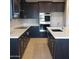 Modern kitchen featuring dark cabinetry and quartz countertops at 1907 W Brooke Ln, Queen Creek, AZ 85144