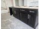 Close-up of a dark wood kitchen island with drawers and cabinet space, promising both style and function at 1907 W Brooke Ln, Queen Creek, AZ 85144