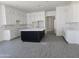 Spacious kitchen featuring white cabinets, a large black island, and modern finishes at 1907 W Brooke Ln, Queen Creek, AZ 85144