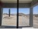 Scenery viewed through a window of desert landscaping with mountains beyond at 1907 W Brooke Ln, Queen Creek, AZ 85144