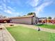 Spacious backyard with artificial putting green, cornhole, and covered patio, ideal for outdoor activities and relaxation at 8450 E Montecito Ave, Scottsdale, AZ 85251