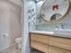 Modern bathroom featuring a floating wood vanity, stylish fixtures and a toilet at 8450 E Montecito Ave, Scottsdale, AZ 85251