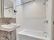 Clean bathroom featuring a tub with shower, white tiling, and ample lighting, creating a bright and functional space at 8450 E Montecito Ave, Scottsdale, AZ 85251