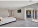 Bright bedroom featuring tiled floors, a door leading to a patio and mounted television at 8450 E Montecito Ave, Scottsdale, AZ 85251