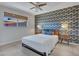 Bright bedroom featuring a queen bed, ceiling fan, natural window light and modern accent wall at 8450 E Montecito Ave, Scottsdale, AZ 85251