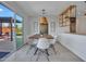 Bright dining room with modern table, chairs, and access to outdoor patio at 8450 E Montecito Ave, Scottsdale, AZ 85251