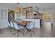 Dining room features a modern light fixture and views of the open concept kitchen and backyard at 8450 E Montecito Ave, Scottsdale, AZ 85251