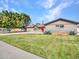 Charming single-story home with mature landscaping and a well-manicured lawn at 8450 E Montecito Ave, Scottsdale, AZ 85251