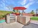 Outdoor kitchen with stainless steel grill, concrete counter tops and outdoor seating at 8450 E Montecito Ave, Scottsdale, AZ 85251