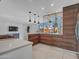 Bright kitchen with breakfast bar, modern pendant lights, and sleek cabinetry at 8450 E Montecito Ave, Scottsdale, AZ 85251