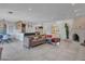 Open concept living room flows into dining area with tiled floors, stone fireplace, and modern decor at 8450 E Montecito Ave, Scottsdale, AZ 85251