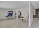 Open-concept living room with tile floors, a basketball game and arched doorways at 8450 E Montecito Ave, Scottsdale, AZ 85251