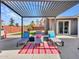 Covered patio with lounge chairs, pergola, striped rug and a view of the backyard and pool at 8450 E Montecito Ave, Scottsdale, AZ 85251